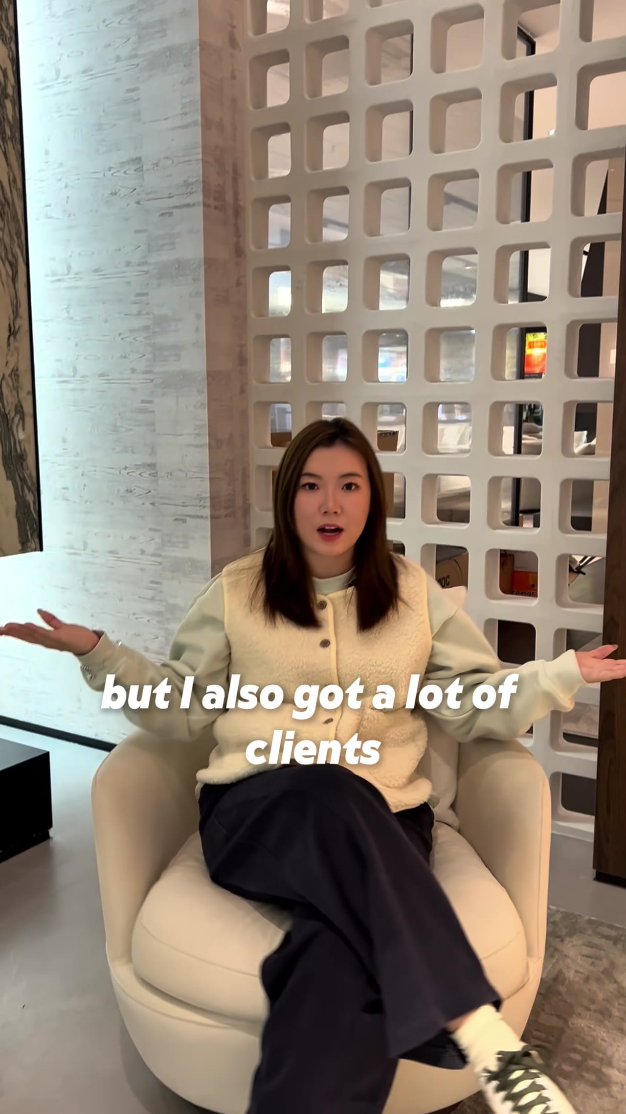 Woman discusses client acquisition in a modern showroom setting