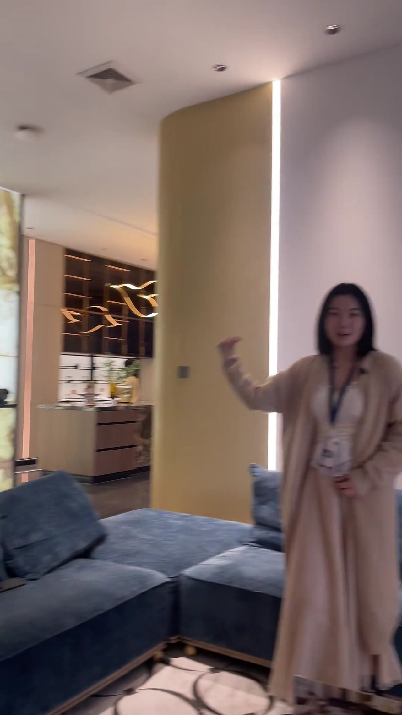 Woman presents furniture in a George Group showroom