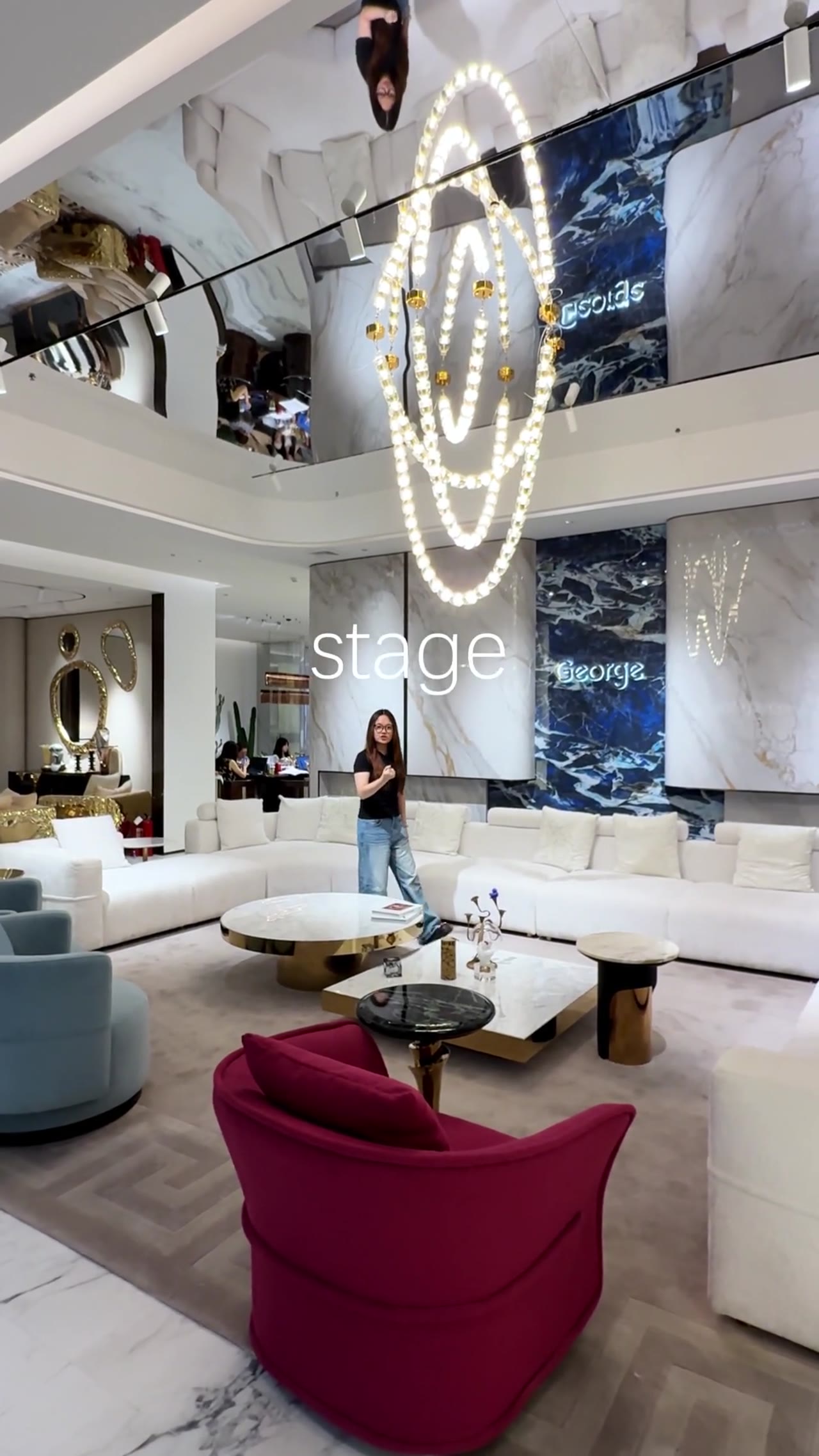 Woman presents furniture in a modern showroom for George Group