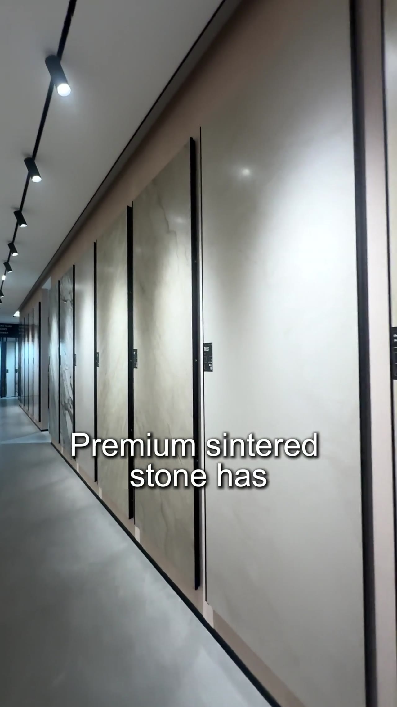 Woman opens refrigerator in modern kitchen showroom