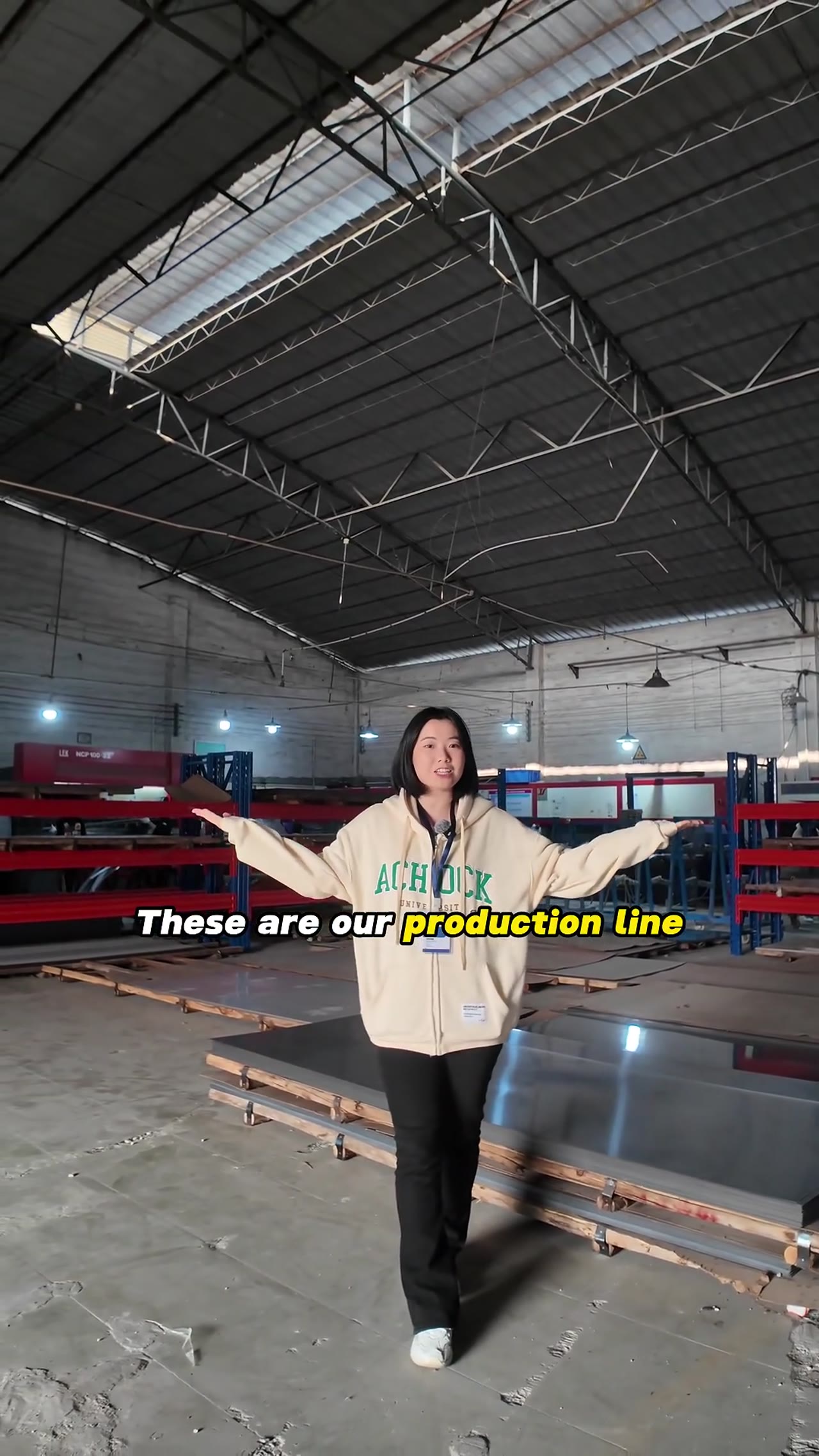 Woman demonstrates kitchen cabinet features in showroom