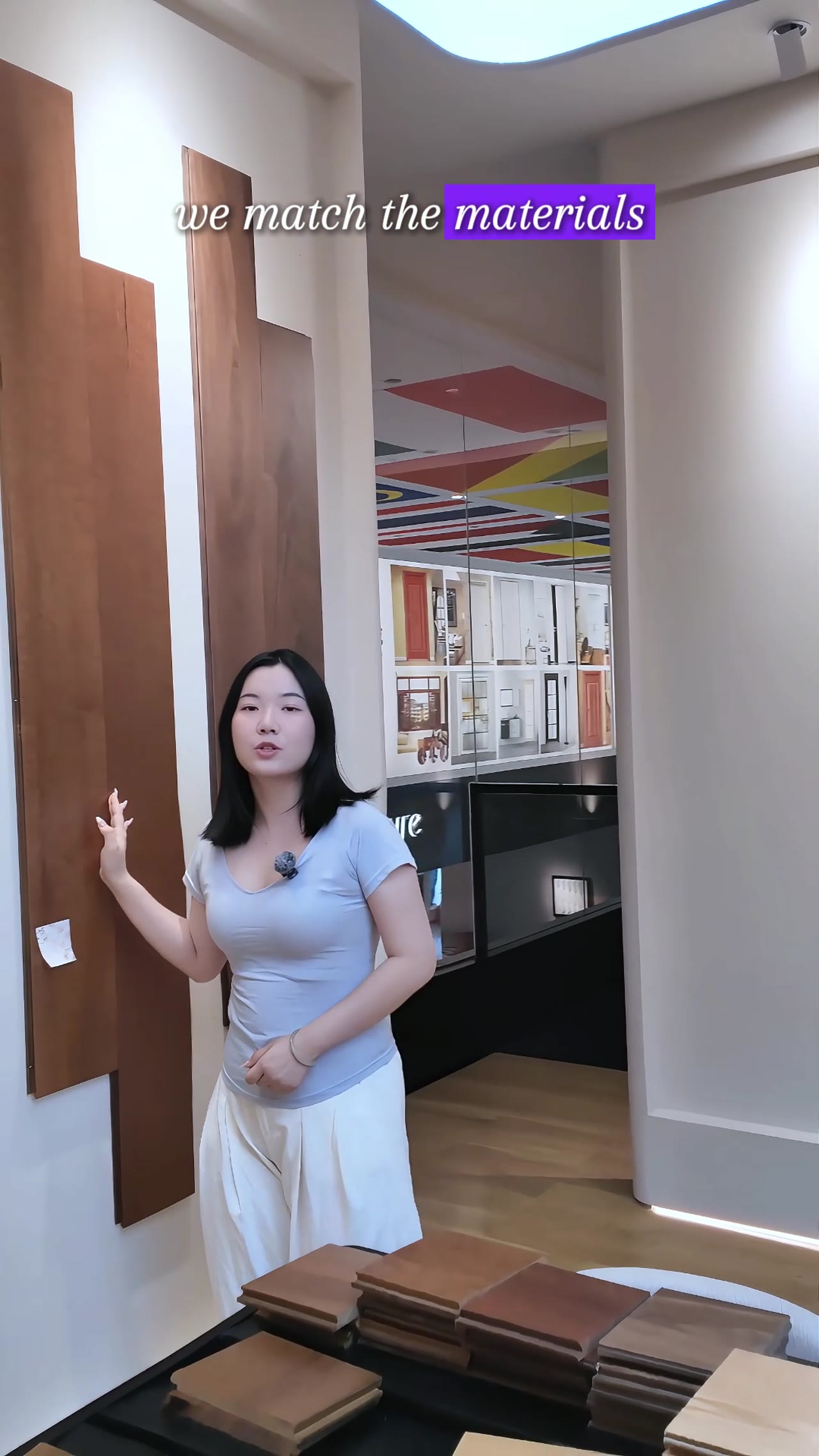 Woman presents kitchen cabinets in a George Group showroom